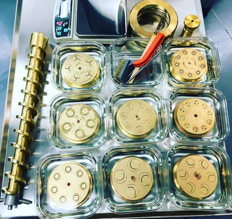 An amazing little machine mixes and forms pasta dough into different shapes using precision extrusion dies that cost several hundred bucks each. BOB YESBEK PHOTOS